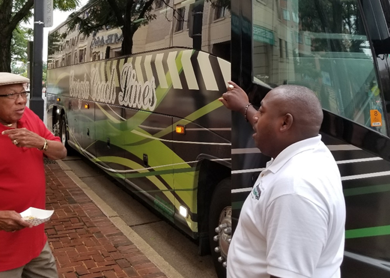 Man standing in front of charter bus